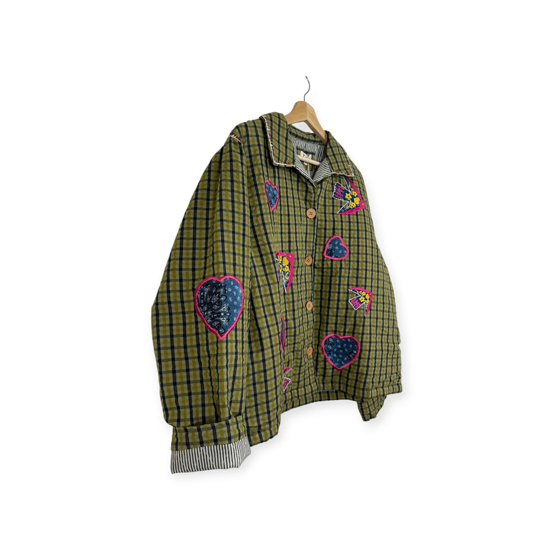 Birch Island Collective olive green and black plaid quilted jacket with heart and bird appliqués and button front.